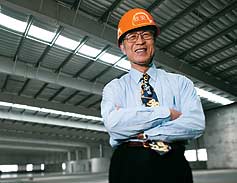 CUSTOMER SATISFACTION // Jian Kai, Chief Engineer Shanghai Xinan (Group) Co. is a satisfied customer of BlueScope Butler in China. He is pictured inside a completed pre-engineered building (PEB) at Shanghai Industrial Park.